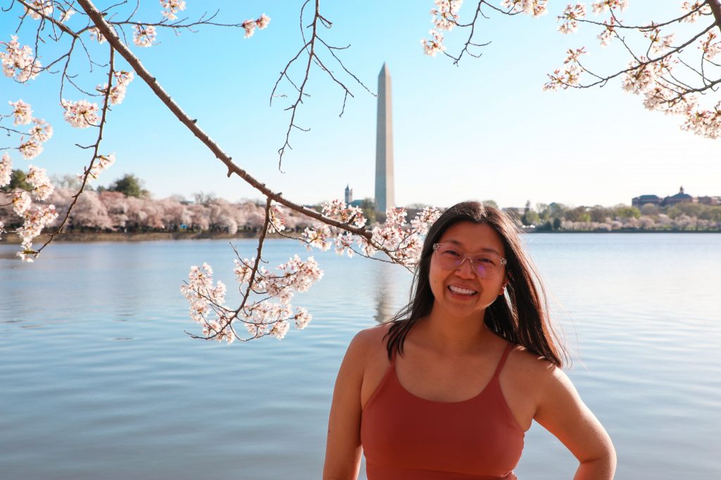 Girl in pink top in front of washington monument at dc tidal basin