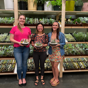 Faye and friends holding a succulent terrarium she built