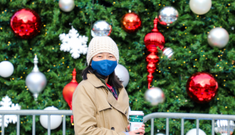 Faye standing in front of holiday decorations