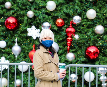 Faye standing in front of holiday decorations