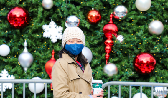 Faye standing in front of holiday decorations